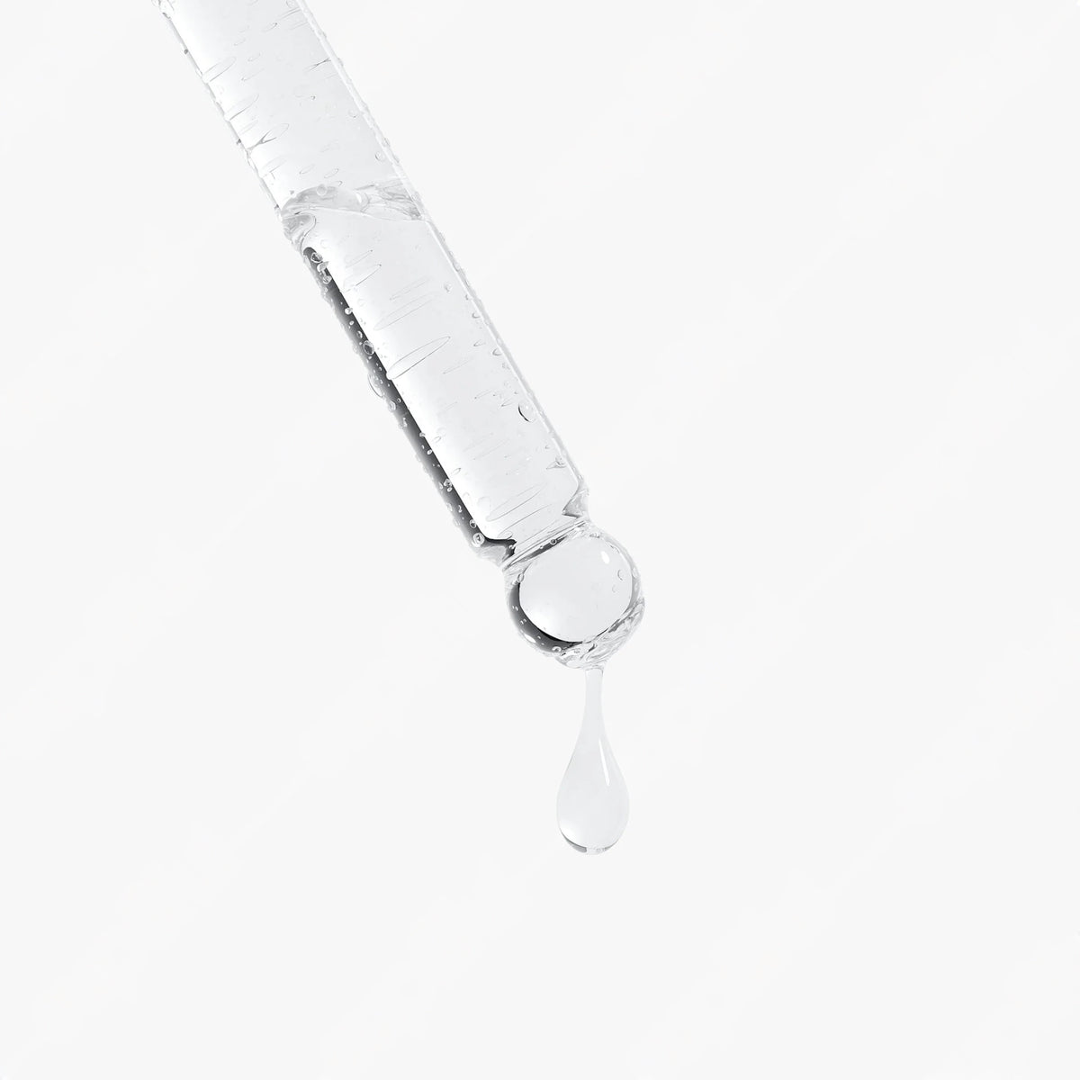 Close-up of PDRN Brightening Serum dropping from the dropper