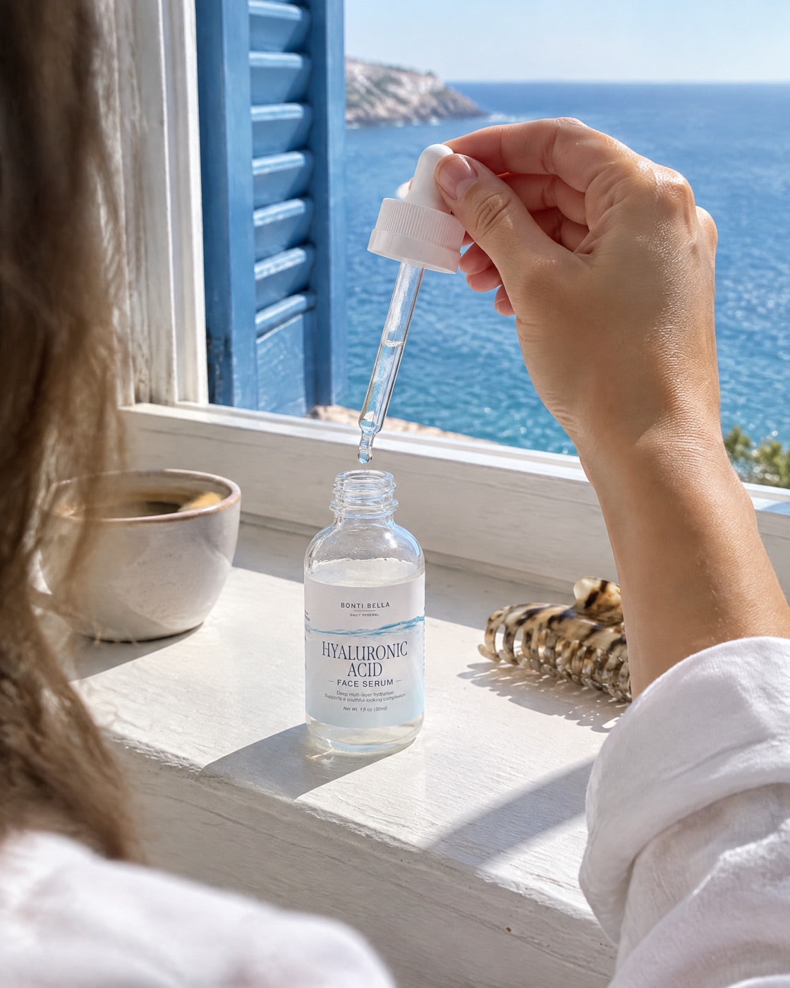 A dropper of Hyaluronic Acid Face Serum held above an open palm